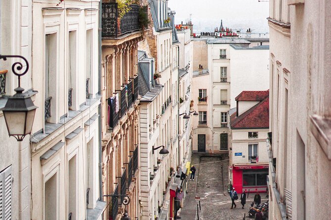 Exclusive Walking Tour In Montmartre With Local Guide - Starting beneath the red windmill at Blanche