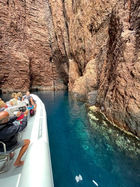 From Sagone/Cargèse: Scandola and Calanques de Piana Cruise - Calanques de Piana and Capo Rosso caves: red cliffs, an arch, and big drama