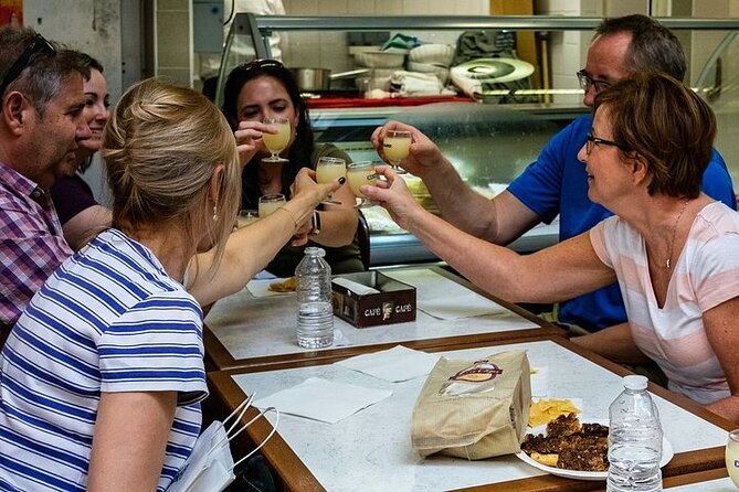 Half-Day Walking Food Tour in Nice with Lunch - Opera de Nice area: sampling at a shop with staying power
