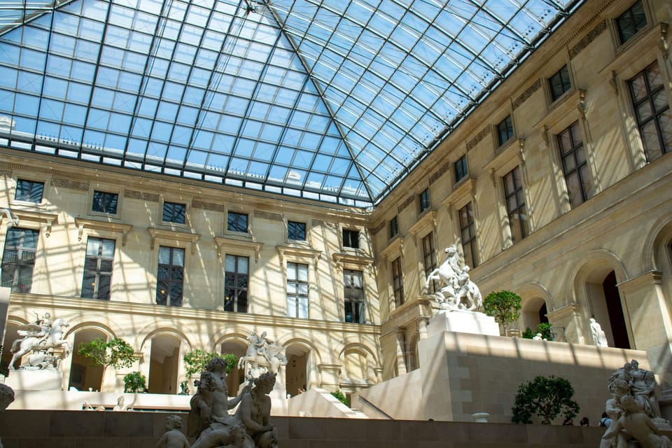 Louvre Private Tour: The Essentials and More w/ Expert Guide - Starting point: that Louis XIV statue copy sets a tone