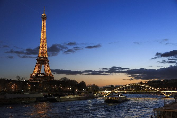 Paris By Night with Seine River Cruise and Roundtrip Luxury Transportation - The Eiffel Tower and Paris landmarks after dark