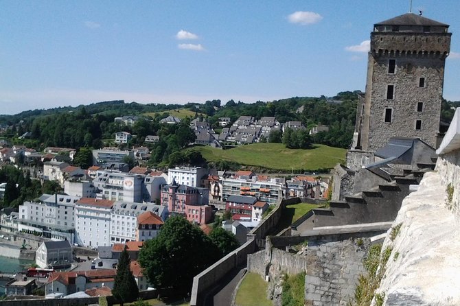 Private Guided History tour of Lourdes - Stop 1: Sanctuaire Notre Dame de Lourdes, grotto context, basilicas, and holy water